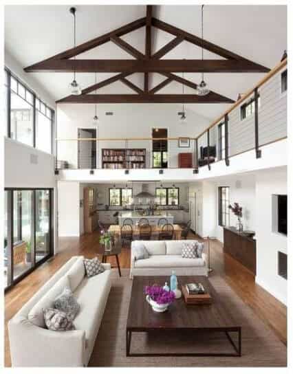 Open concept floor plan modern farmhouse with vaulted ceiling and balcony walkway