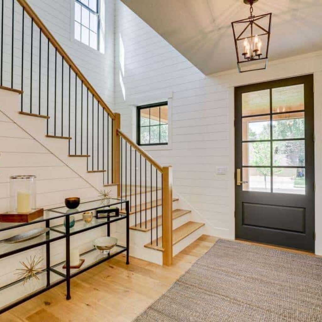 entryway foyer ideas with shiplap walls and wood flooring and glass door