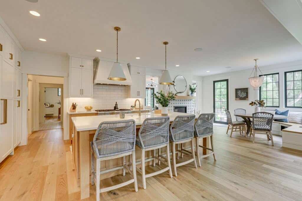 white kitchen with island and brass hardware white oak flooring