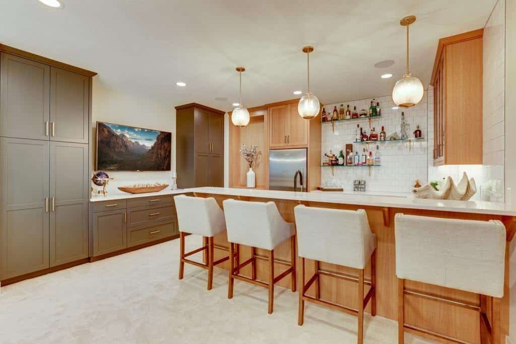 lower level basement kitchen and bar with appliances white oak cabinets