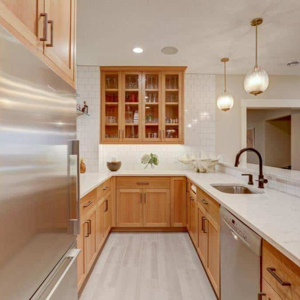 lower level basement kitchen with appliances sink white oak cabinets