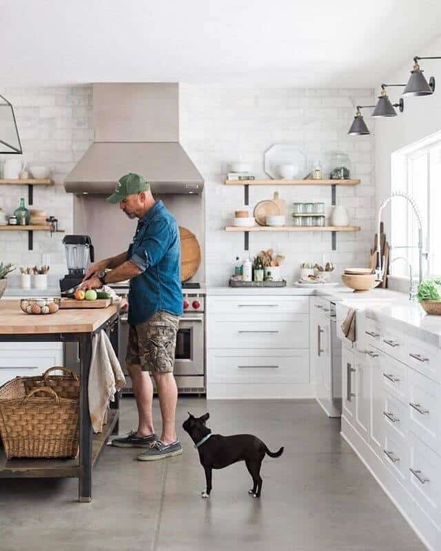 concrete cement flooring subway tile wall white kitchen cabinets industrial butcher block island