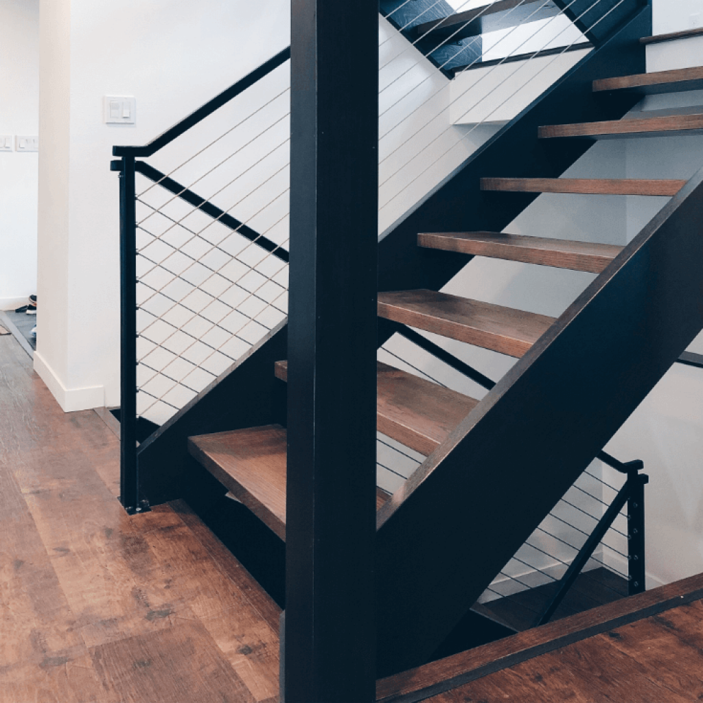 open tread oak wood stairs with wood stringers, metal top railing and cable railing system diy and built by mark and leah reinert from down leahs lane