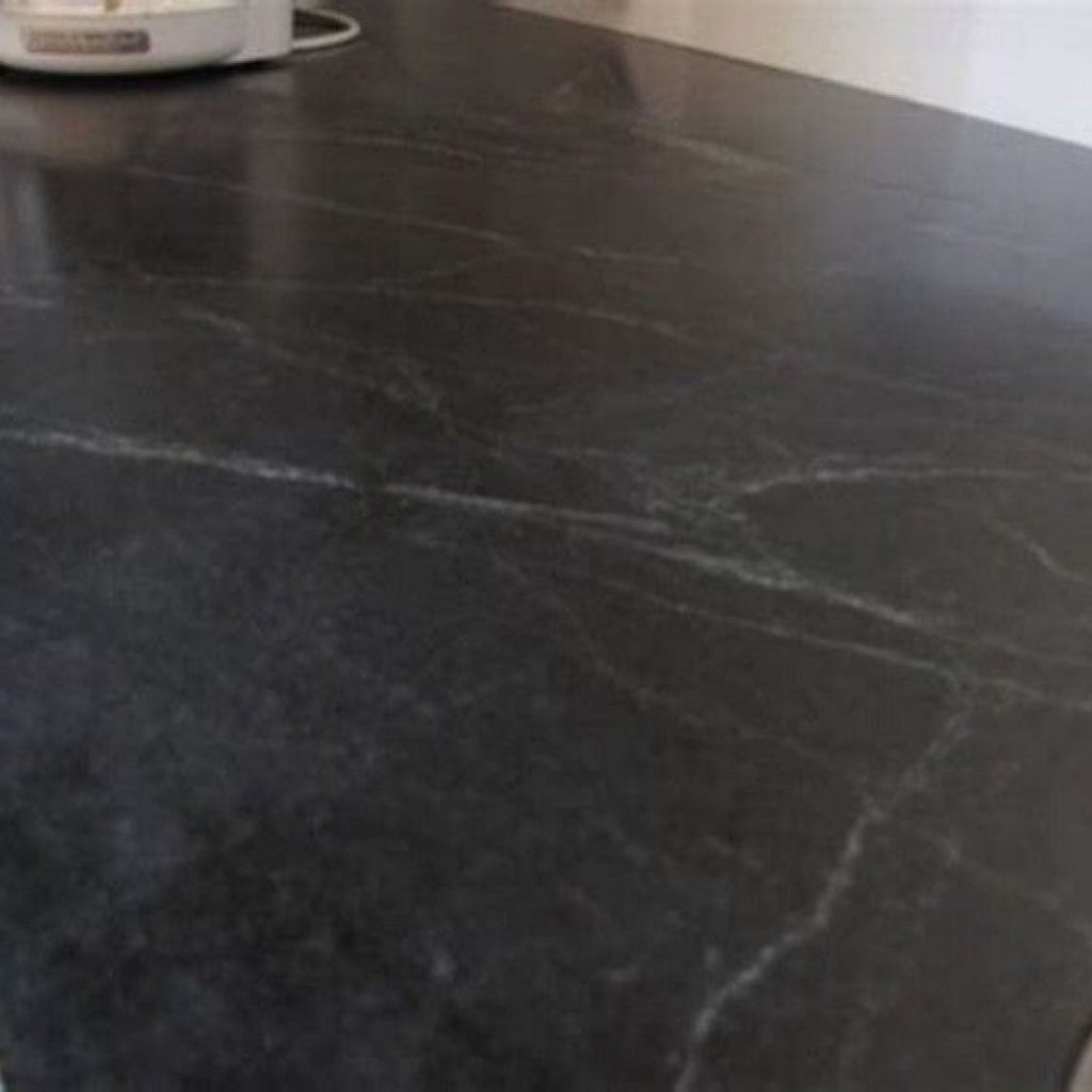 Black honed granite with soft white movement swirls in it.