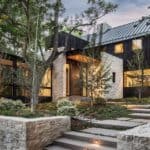 A luxury dark modern farmhouse with beige stone creates a stunning feel to this dream home. This home was nominated for Home of the Year and was designed by Surround Architect, built by Morningstar Home and pic by Jensen Walker. #downleahslane #darkhouse #dreamhome #luxuryhome #stoneexterior #exteriorcolor #homeoftheyear #barndominium #barnhouse #ranchhouse #steelroof #blackhouse #exteriorideas #exteriordesigns