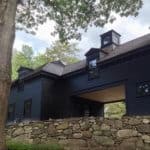 Beautiful dark modern farmhouse exterior with cupola accents and car port to add to the charm. Black siding color with black windows and doors adds drama to this custom home. Via David Dumas Architecture. #darkhouse #darkexterior #blackhouse #blackexterior #cupola #modernfarmhouse #carport