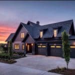 Stunning black house with board and batten siding, black windows and black doors adds drama to this exterior. Constructed by Legend Homes, photo by Reed Brown.